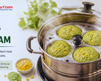Steaming spinach corn idlis until soft and fluffy